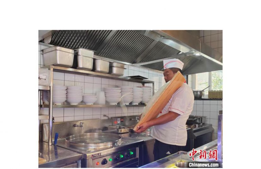 赵老七飞刀削面制作技艺第五代传人赵喜平正在制作刀削面。