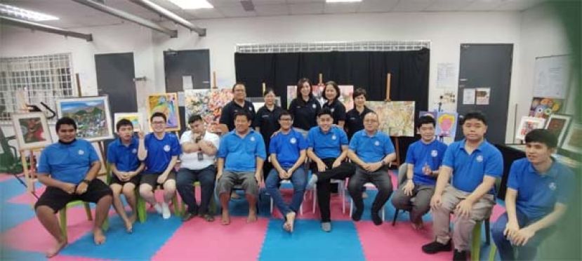 前排为参展的古晋自闭症协会学生艺术家和该协会理事合影。后排左起为该协会秘书督安里吉、会长陈仁爱、筹委会主席杨佳玲、理事刘雪美以及财政黄丽霞。