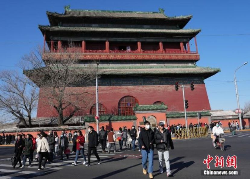 2023年2月24日，北京春光明媚，游客从鼓楼前经过。