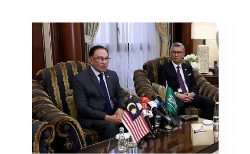 首相安华向媒体发表谈话，右为东姑扎夫鲁。