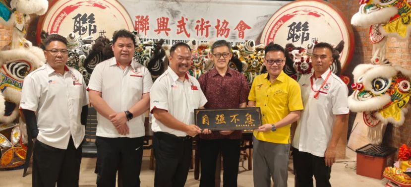 ??联兴武术协会副会长兼发展与竞赛主任杨子然（左三）赠送纪念品予该会法律顾问符祥威（右二）。