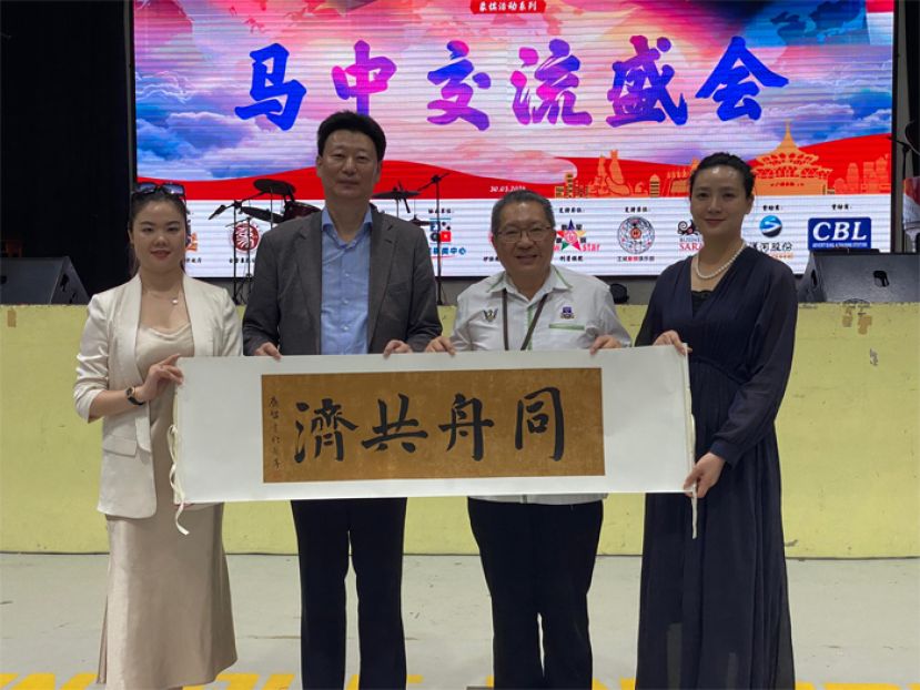 中国对外贸易理事会副理事长郎晓雷（左二）赠送纪念品给古晋南市市长黄鸿圣（右二）。左为杭州艺星文化传播集团董事长罗银芬及右为中国长城艺术文化中心有限公司总经理钱小鸿。