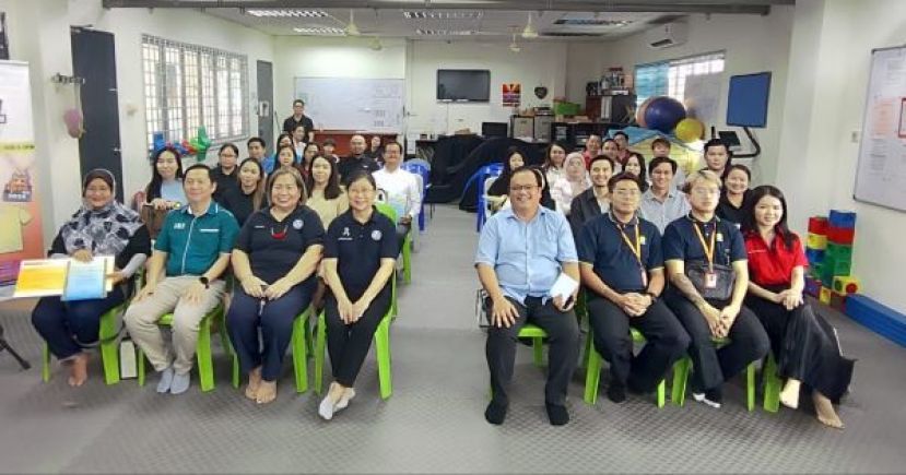 在义跑赞助人移交模拟支票仪式后的一张大合影。左二起为活动伙伴余国雄、古晋自闭症协会副主席吴惜珠以及主席陈仁爱：右四为该会秘书兼活动筹委会主席杜安。