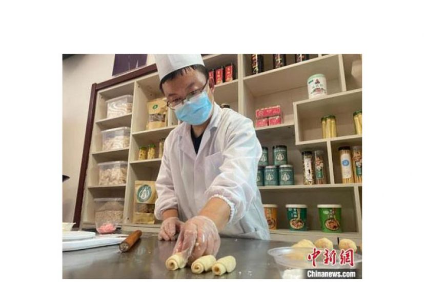 面点师在摆放饼皮。