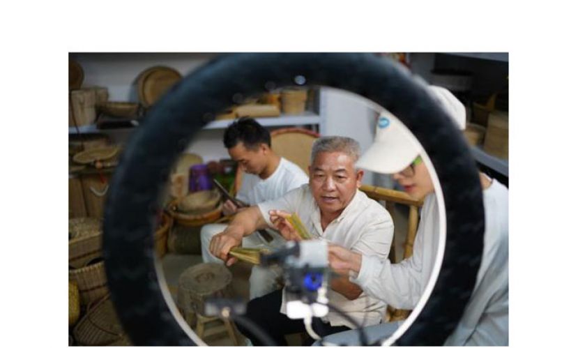 &ldquo;李年根与团队成员通过视频直播介绍他们制作的竹制品。