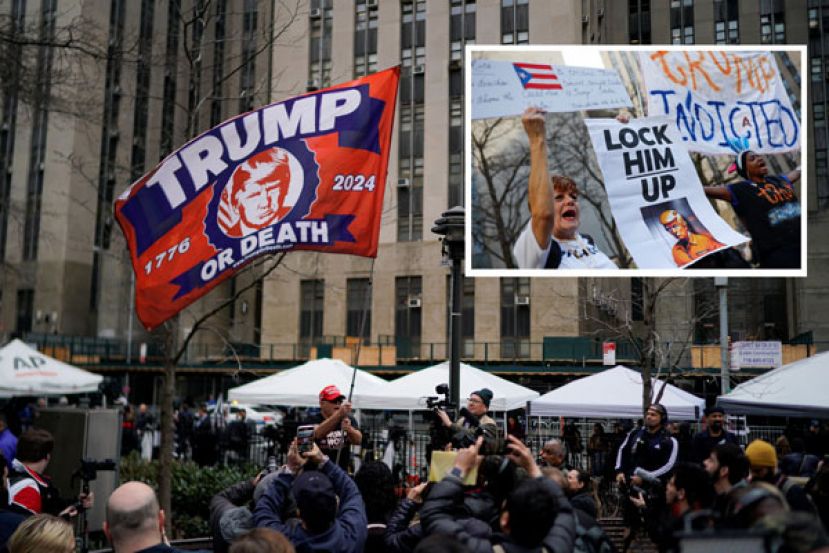 法院外支持者高举特朗普大旗，而反特朗普民众则高举标语&ldquo;把他关起来&rdquo;。