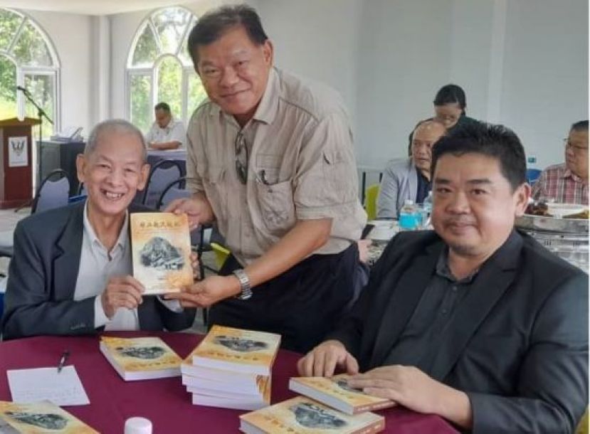 杨曜远（左）赠其新书《华工起义追忆》予陈中兴；右为本固鲁温武胜。