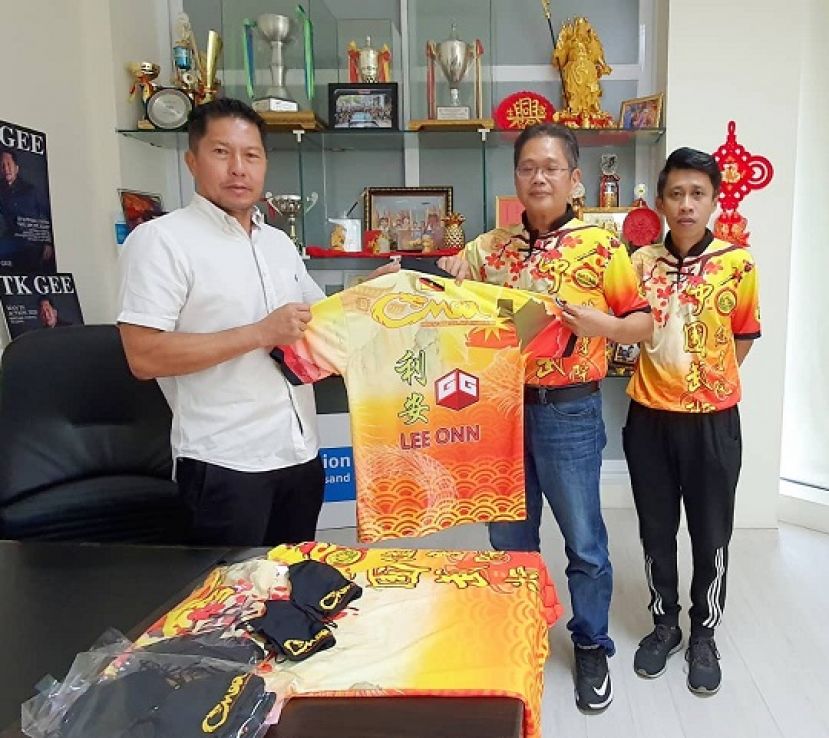 甲必丹陈君义（右）移交赞助的制服于该院教练阮锦鹏（中）与江仁仲（左）。