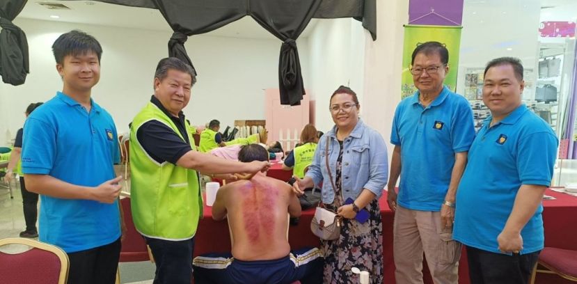 民进党中央妇女组主席阿妮斯（右3）等人观看砂医总会长江宗兴（左2）在义诊为人刮痧保健。右起为甲必丹张淙茗、民进党哥打圣淘沙支部主席黄源泰；左是义诊筹委主席黄国祥（左）。