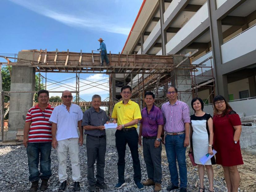 砂首长署政治秘书陈开（左四）代表拿督沈桂贤移交拨款给下港中华公学。