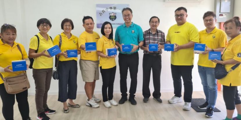 人联党朋岭支部副主席暨砂总理政治秘书许德婉（左5）连同支部其他领袖将检测剂移交给一中校方时影。