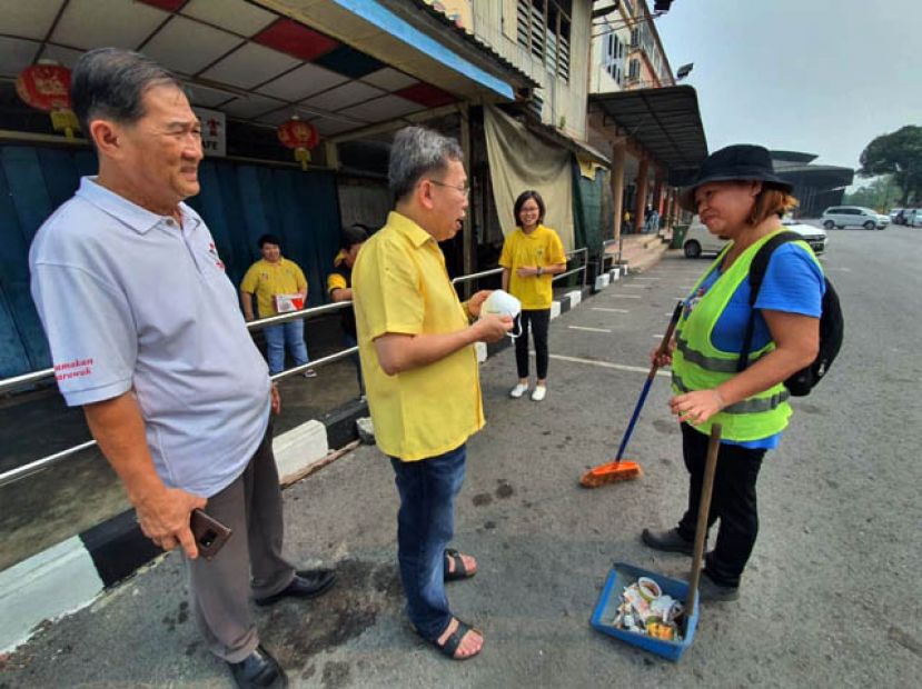 拿督沈桂贤（左二）派发口罩给清洁工人。