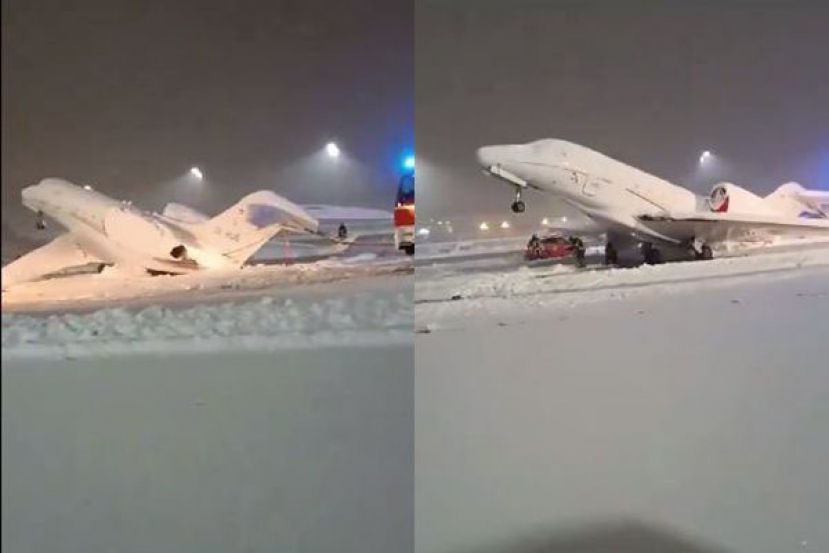 慕尼黑机场的停机坪与飞机被大雪覆盖，工作人员忙著清除。