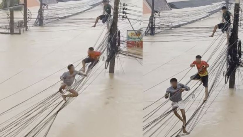 受困居民竟然沿着电线杆之间的电缆攀爬逃生。