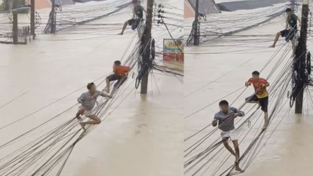 受困居民竟然沿着电线杆之间的电缆攀爬逃生。