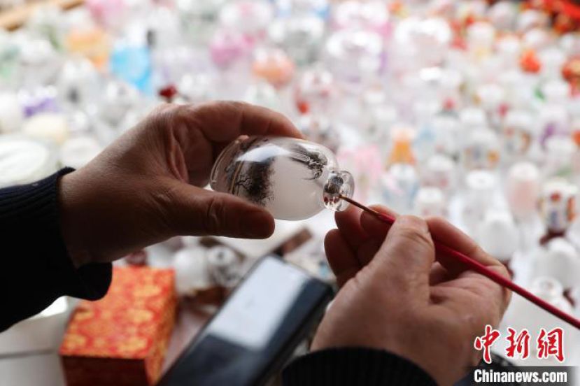 艾福多正在创作内画鼻烟壶。