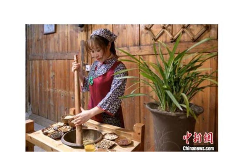 &ldquo;80后&rdquo;擂茶师李华正在制作客家擂茶。