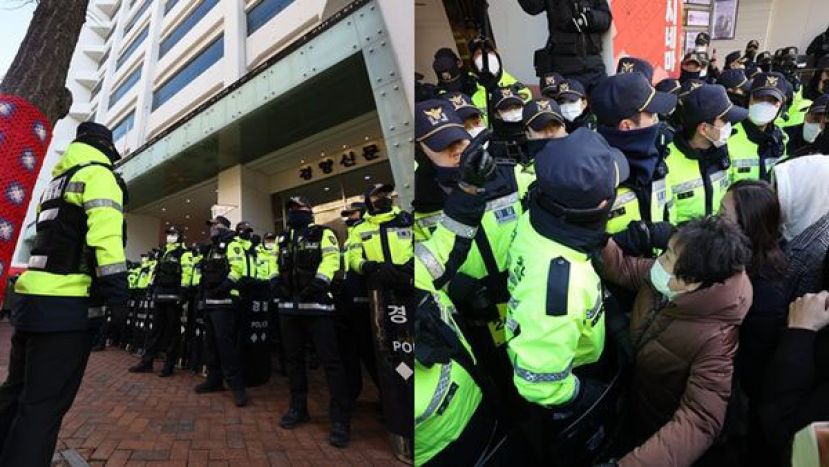 韩国国情院、警察厅18日上午针对民主劳总总部试图执行扣押搜索，一旁则是进步派大报&ldquo;京乡新闻&rdquo;。