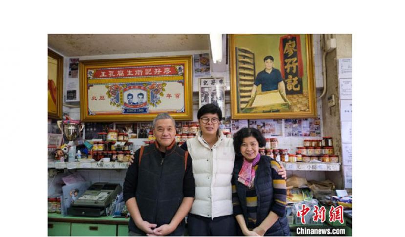 廖晃业与父母在店内合照。