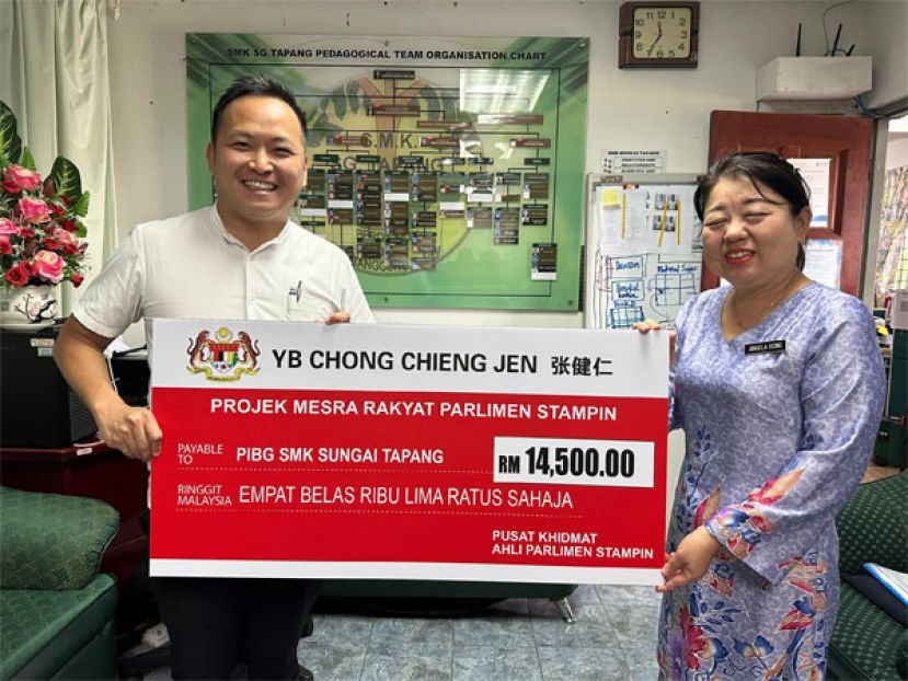 张健仁特别助理江峰年将拨款移交给校方。