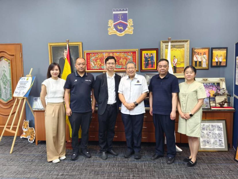 成都市新都区副区长胡蓝（左三）与代表团成员拜会古晋南市市长拿督黄鸿圣（右三）。