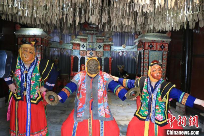 头戴面具的傩戏师在贵州省铜仁市德江县表演傩戏。