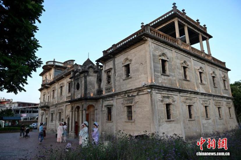 朝东楼是福建晋江梧林传统村落的第一座钢筋水泥建筑。游客在朝东楼前拍照留念。