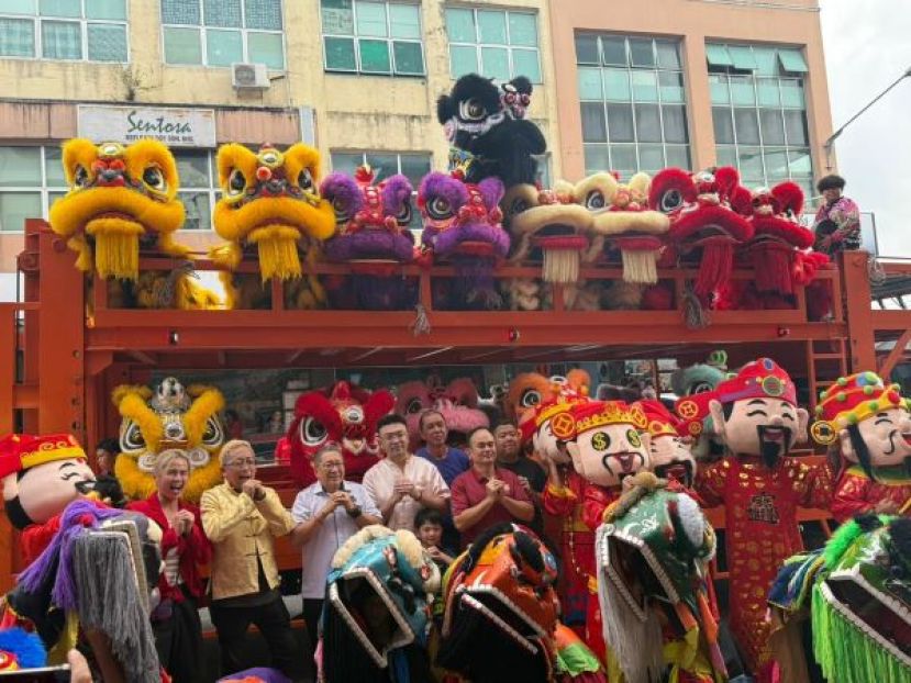 郑摩多专卖店元宵庆典场面热闹非凡，盛邀30只瑞狮同场献艺，多位财神爷助阵增添喜气。古晋南市市长拿督黄鸿圣（左三）受邀出席与郑摩多专卖店董事郑国栋市议员（左四）一同向民众拜年，并见证派送1000包白米，与市民共庆元宵佳节。