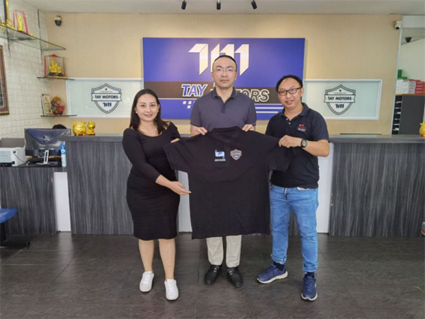 Tay Motors董事兼巴达旺市议员郑国栋（中）移交赞助制服给予砂拉越新闻从业员联合总会2023年国家记者日庆典砂拉越代表团团员查芬妮（左）与团员田诗其（右）。