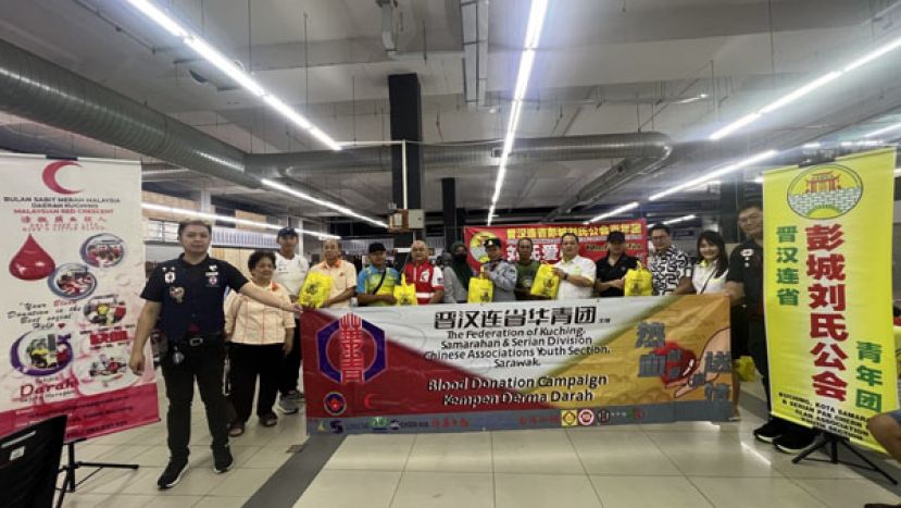 刘氏公会副会长刘织强（左四），古晋区红新月会血液征求组第二副主席杨民士（（左六），刘青团署理团长刘室锋（右三），刘青团团长刘时财（右五），古晋童子军第14团代表赖思伲（右七）移交礼品给成功捐血的人士。左为华青团福利组组长郑建宏。