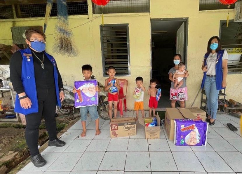 华总福利代表兼妇女组主任张慧娇（右一）与妇女组监察主任朱缮霖（左一）将奶粉，小孩用品及食品移交给相小凤女士（右二）并与小孩们合影。
