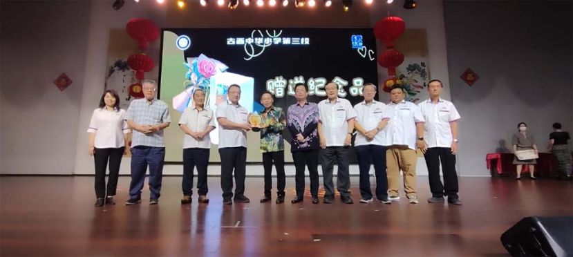 古晋中华小学校董会主席拿督蔡文铎（左四）赠送纪念品给荣休老师陈明发（左五）时影。左起为该校董会财政罗绍凤、名誉顾问刘文侯、执行顾问黄张金发；右起为校董甲必丹唐才茗、鲁晋菘、秘书长张光福、副主席郑文发及三小校长黄玉祥。