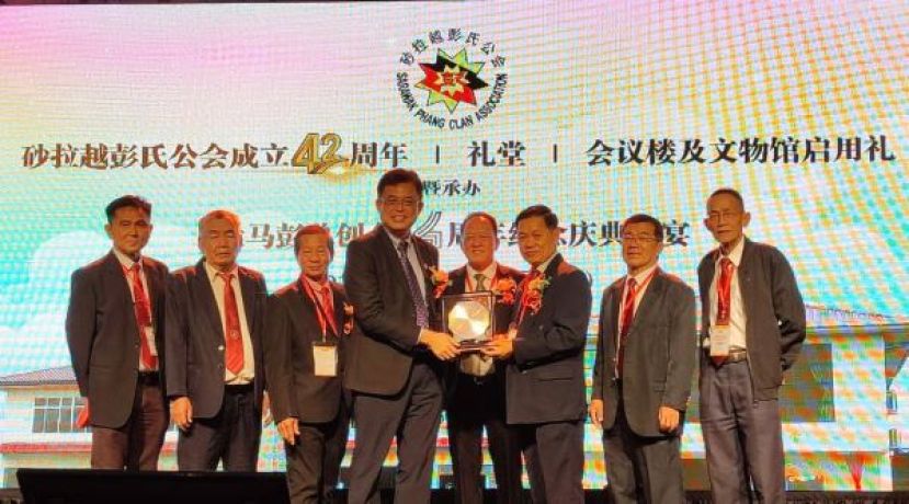 在大马彭总总会长拿督彭永胜（右四）的见证下，砂拉越彭氏公会庆典筹委兼建委会主席的彭国良(右三)赠送纪念品予主宾砂拉越副总理拿督阿玛沈桂贤的代表陈开时影。左起为砂拉越彭氏公会副会长彭国欣、副会长彭志远以及会长彭德洲；右起为副会长彭文碧以及署理会长彭國胜。       大馬彭總總會長拿督彭永勝、