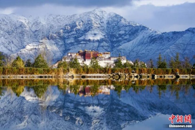 布达拉宫与雪山倒映在拉萨南山湖面。