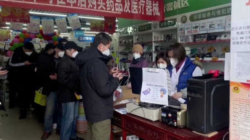 中国松绑防疫限制之后，北京一家药店排队购买药品的民众。