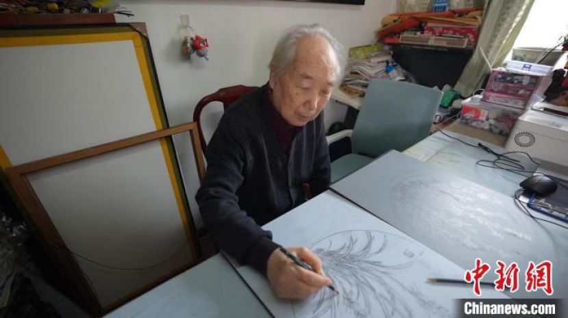 蔺烈正在创作板刻线画底稿。